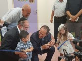 Shalva founder, Kalman Samuels (left), and Mayor of Jerusalem, Nir Barkat (center), help youngsters cut the ribbon at the grand opening of the new National Children’s Center last week.